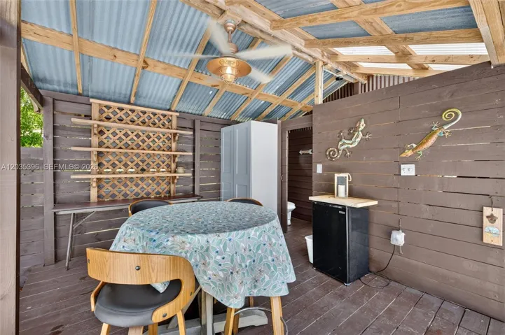 Covered patio area for your outdoor meals / pool bathroom behind it