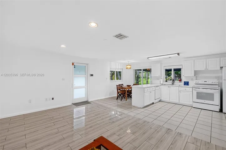 Guest House living room view to kitchen and front door and sliders to the garden and private patio