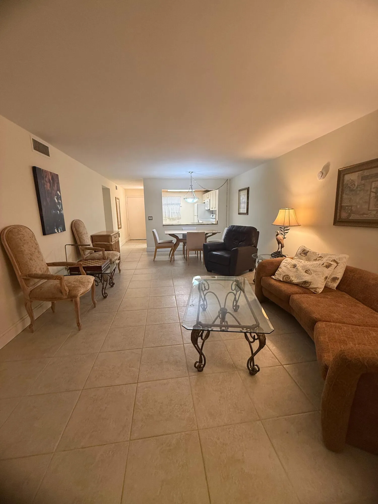 Open-concept living area featuring neutral tile flooring throughout