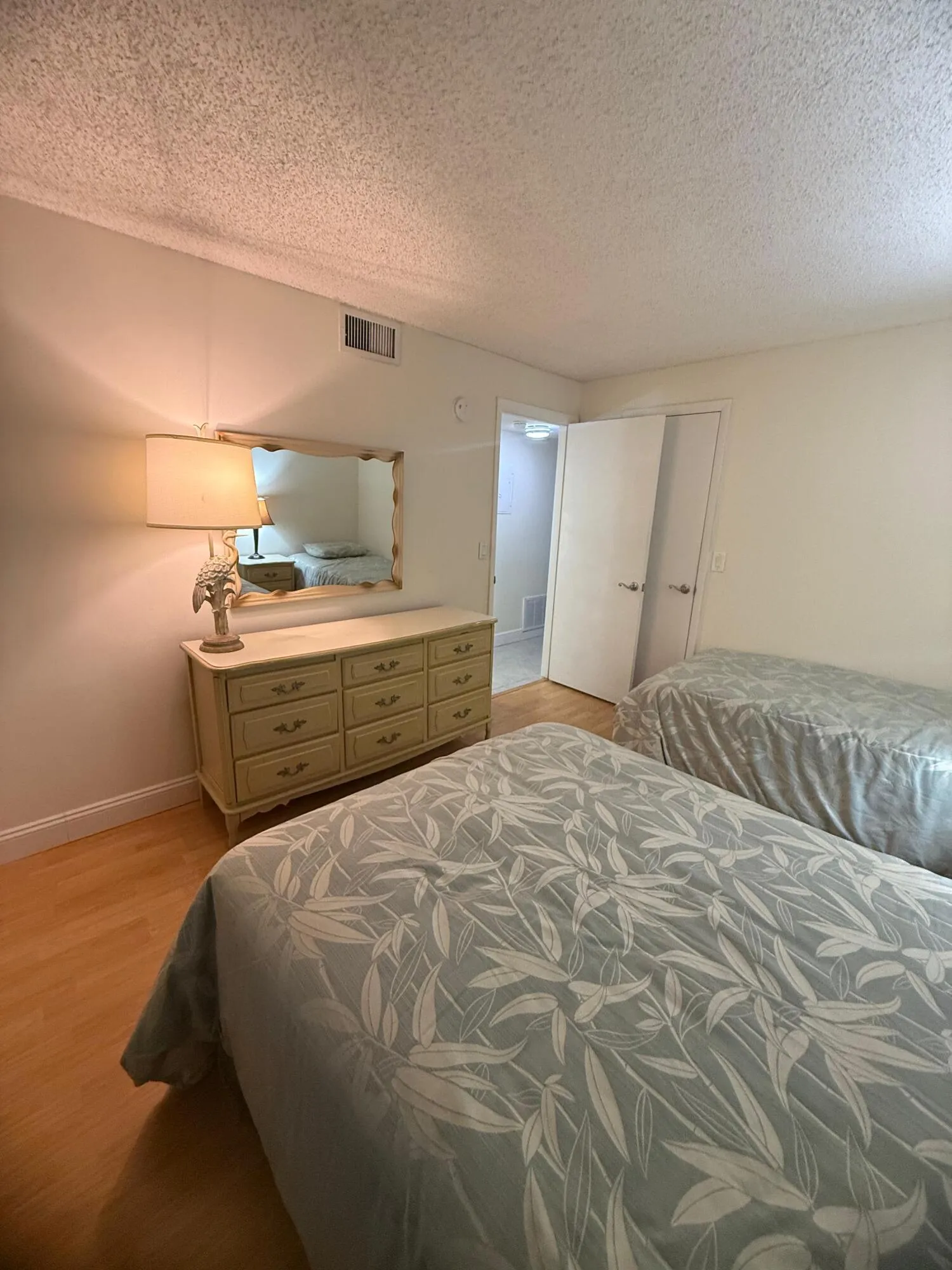 Light wood-finish flooring complements neutral wall tones