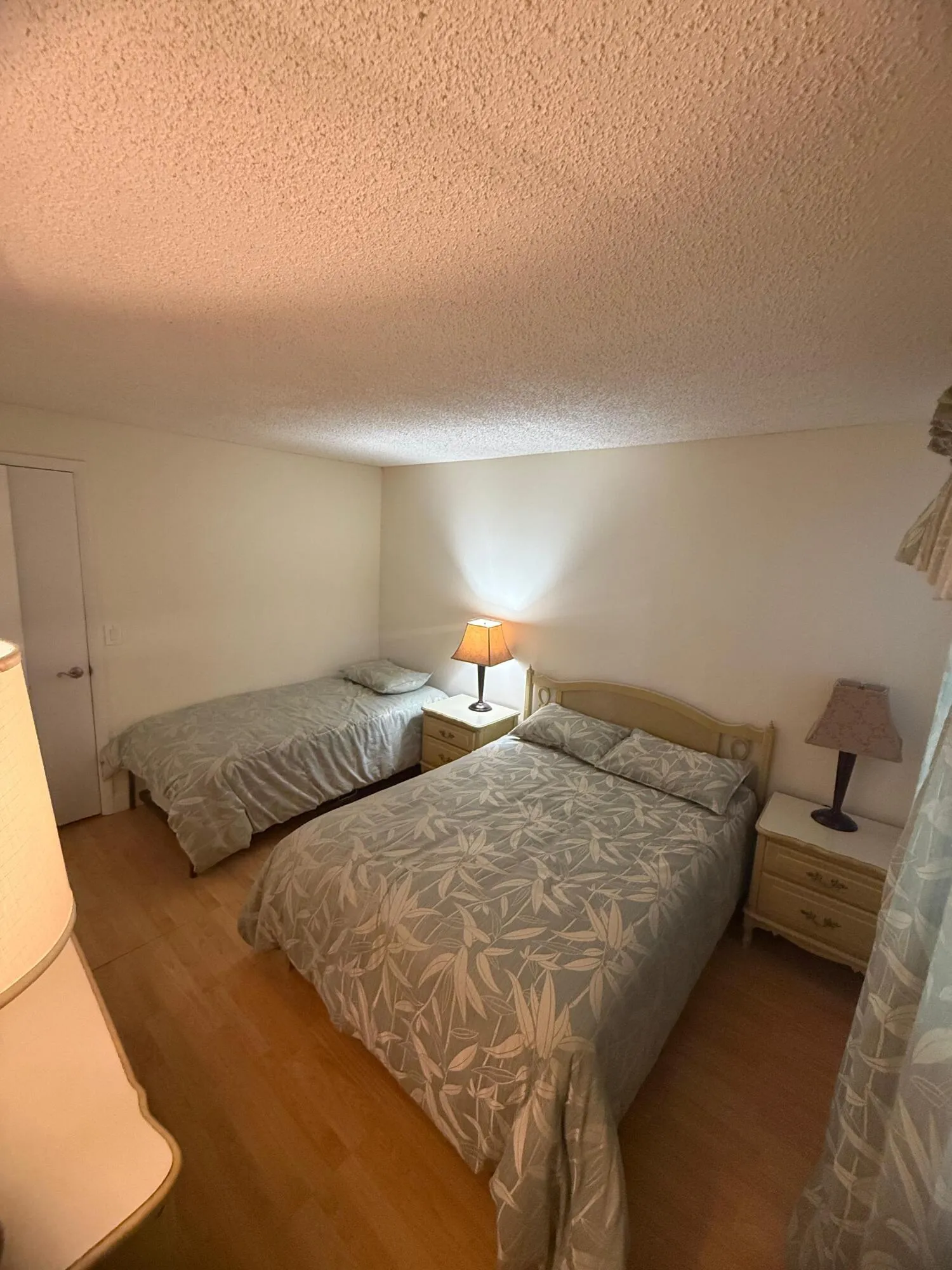 Light wood-finish flooring complements the neutral wall color in this room