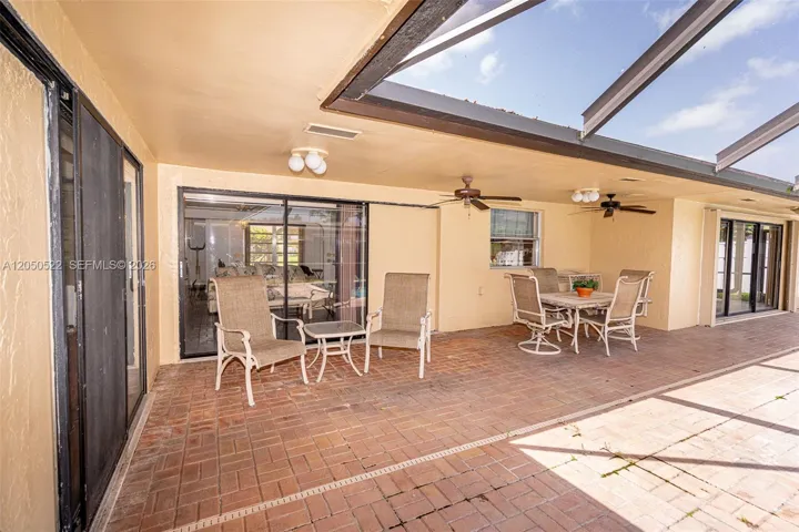covered terrace facing screened-in pool