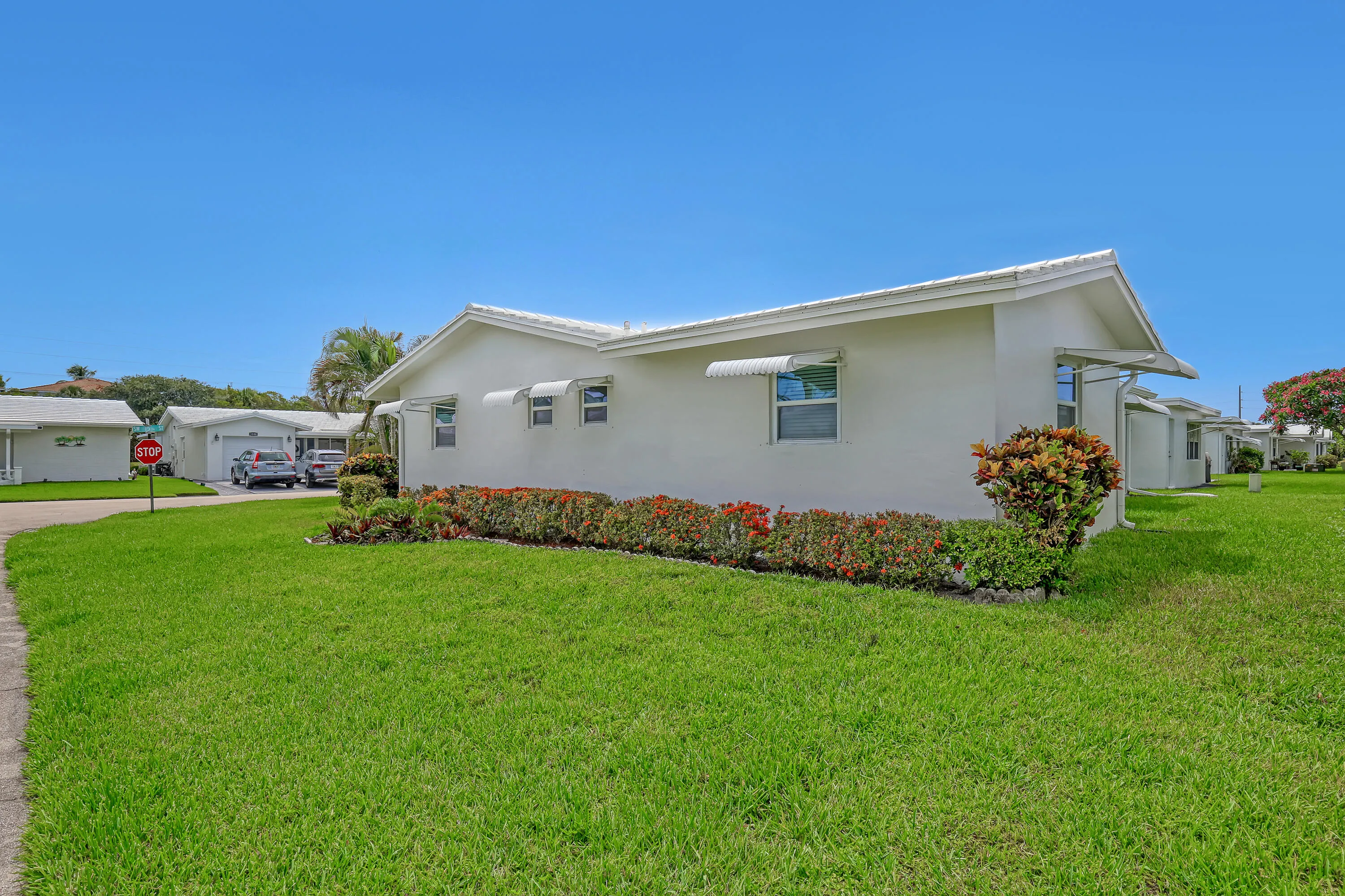 Spacious corner lot on quiet street. Photo of side of home. Home across the street on main canal.