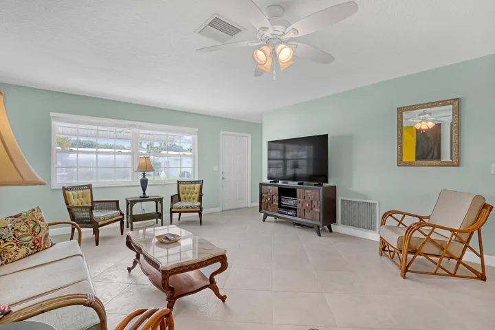 Neutral tile thruout home. Large Living room with ceiling fan and lot of natural light.