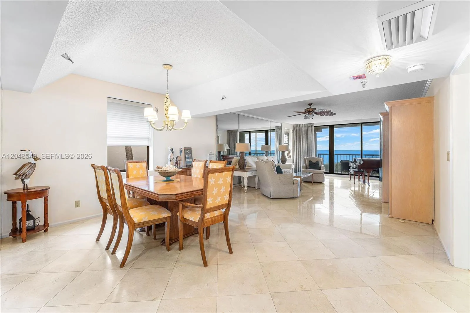 Large dining area with vaulted ceiling and ocean views