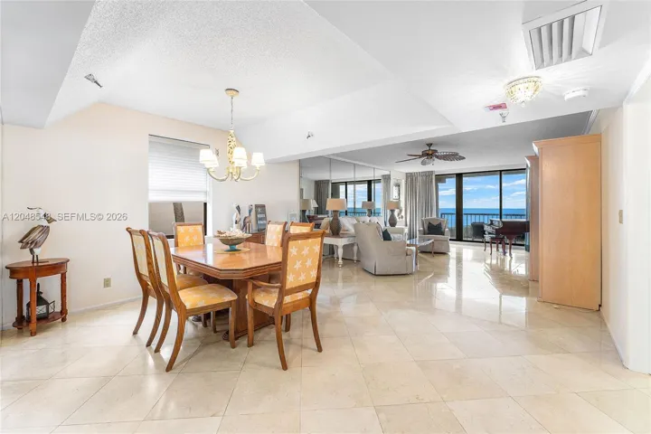 Large dining area with vaulted ceiling and ocean views