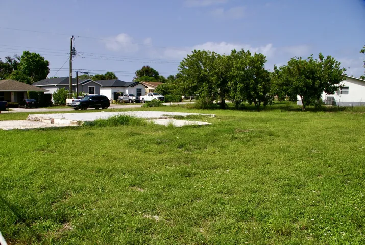Grassy lot with a partial concrete foundation