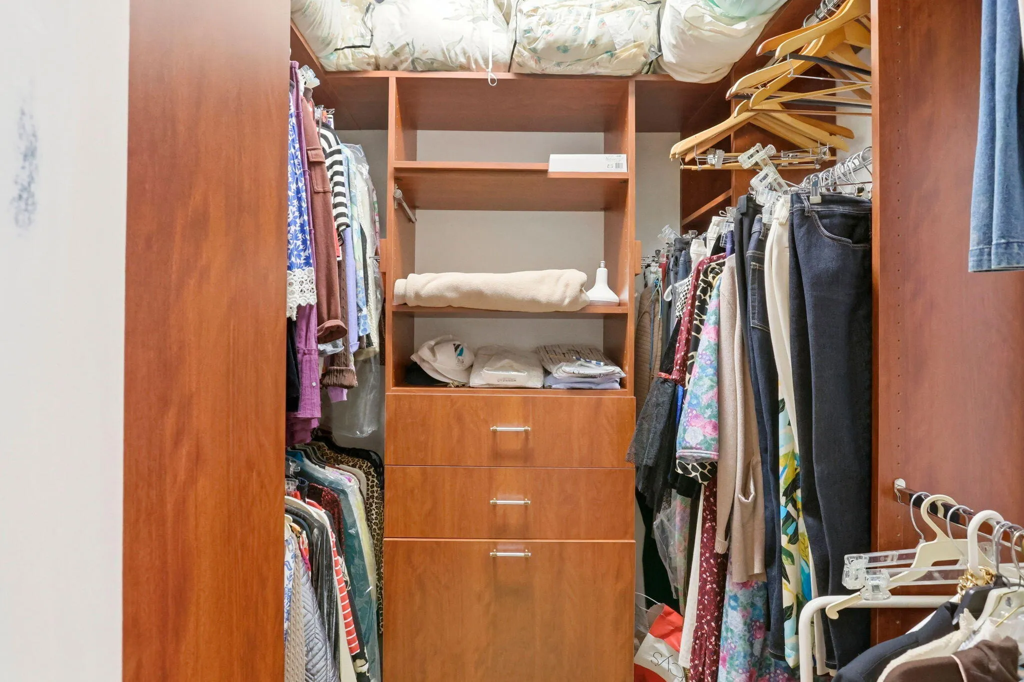 Custom closet system featuring wood-finish cabinetry