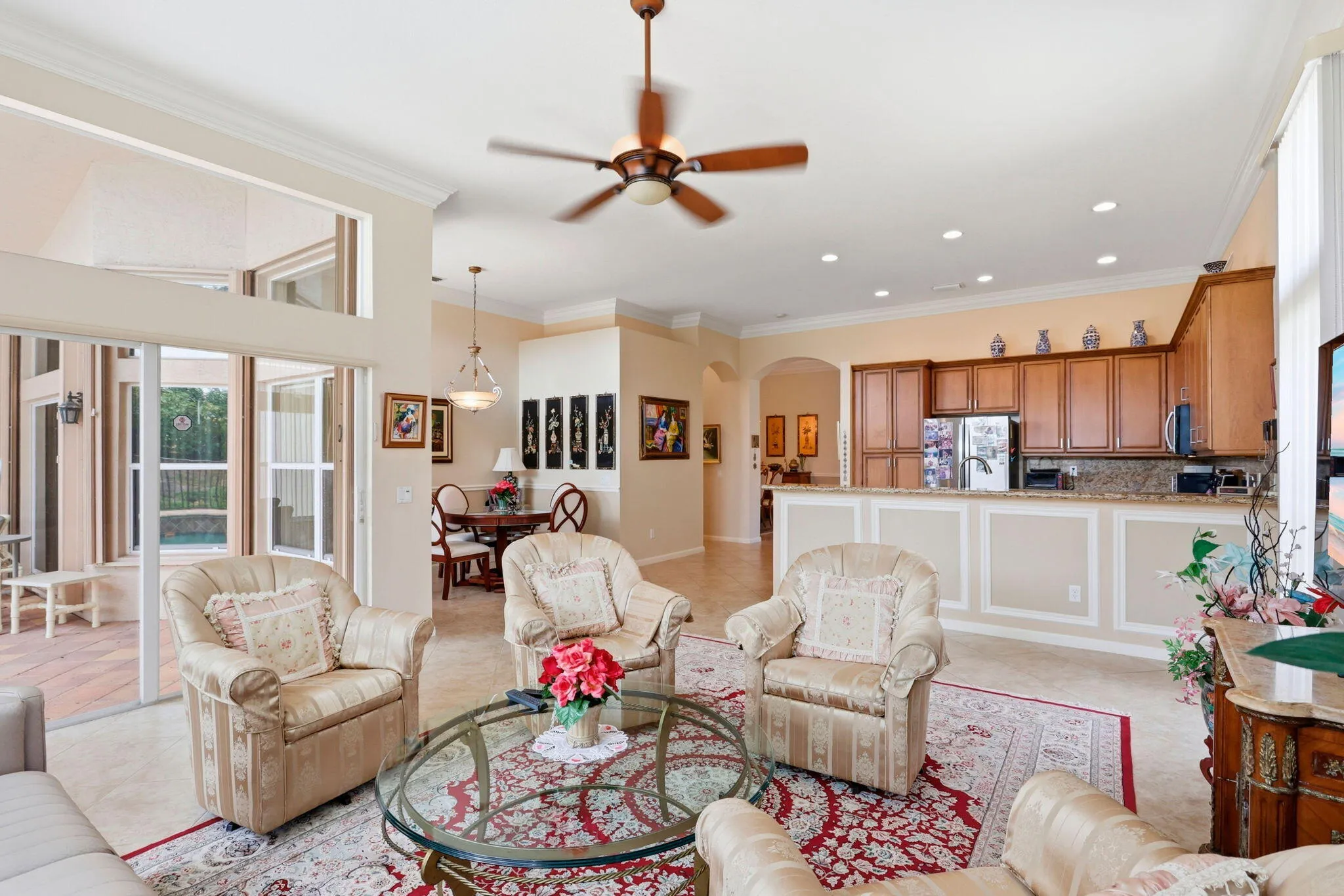 Open concept living area featuring light-toned tile flooring throughout