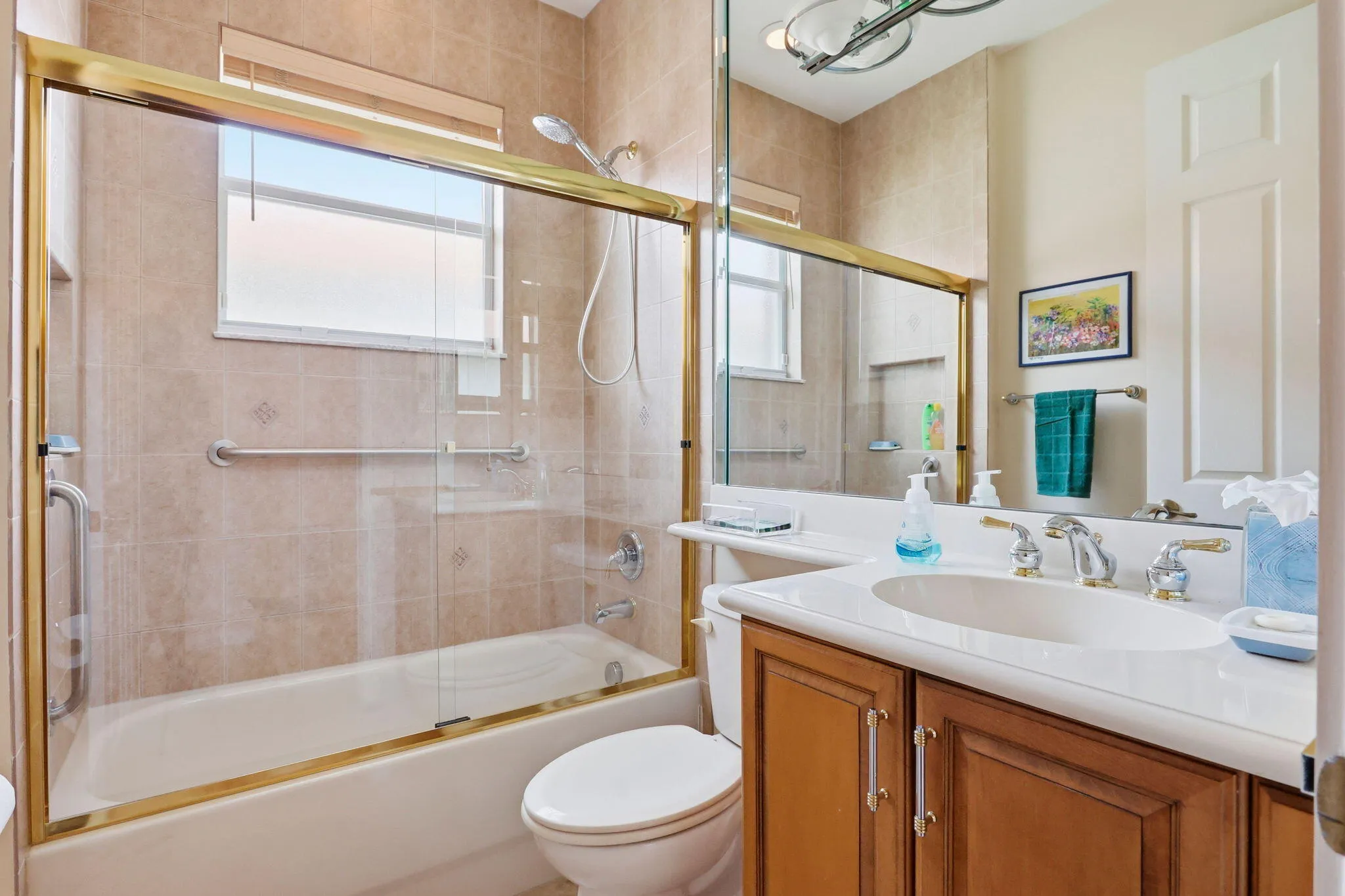 Full bathroom featuring a single vanity with wood-finish cabinetry and a white countertop