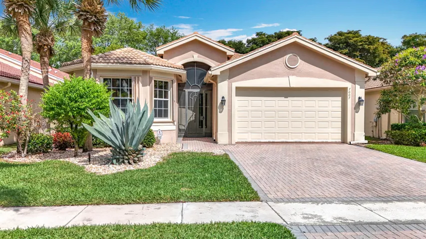 Stucco exterior with a tile roof and an arched entryway