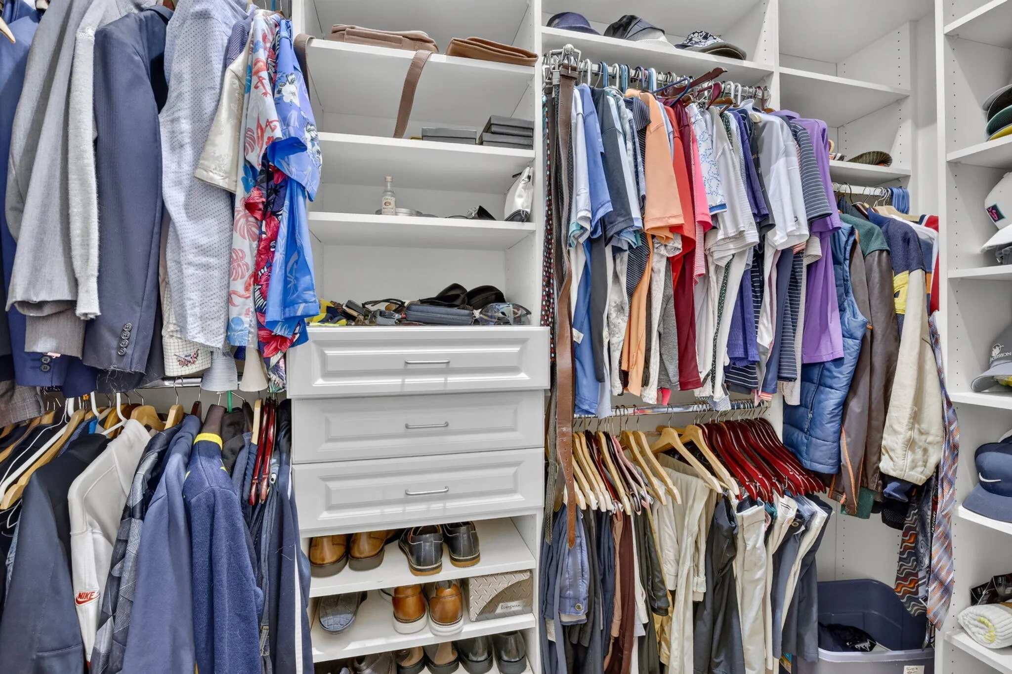 2 Separate Walk-in Closets Across from one Another with Built-Ins.