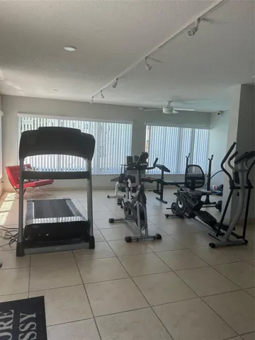 Gym includes: walking tread, bicycle, weights, benches, chairs, steps, verticle blinds, dimmer lighting and fans, centeral a/c,