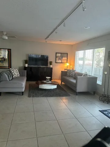 couches, charis tables, lighting, t.v., internet access, vertical window coverings