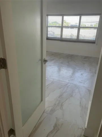 ceramic tile flooring leads into this area. A frosted glass door opens into the room.the window faces west where the views of boats and sunsets are visible. There is wooden horizontal blinds window covering. Hurricane shutters attached to outer window with a roll down manual rod. Fiber internet access modem is included and, in the maintenance fees. there is a walk in closet.