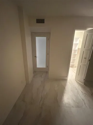 New wood base boards throughout the room and new paint. The walk-in closet new bifold door opens to the left side. New frosted glass door separates the room from the hallway