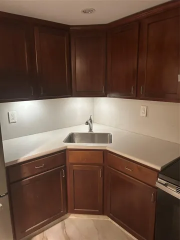 the interior hallway of this unit to the right side has the kitchen