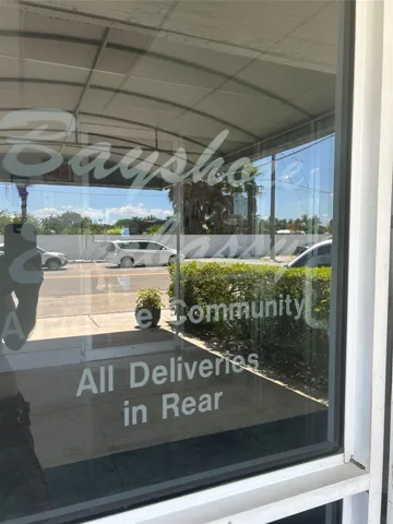 step up to glass door entry where there is sitting lobby with intercom, surveillancecameras, face recognition system using FOB access.