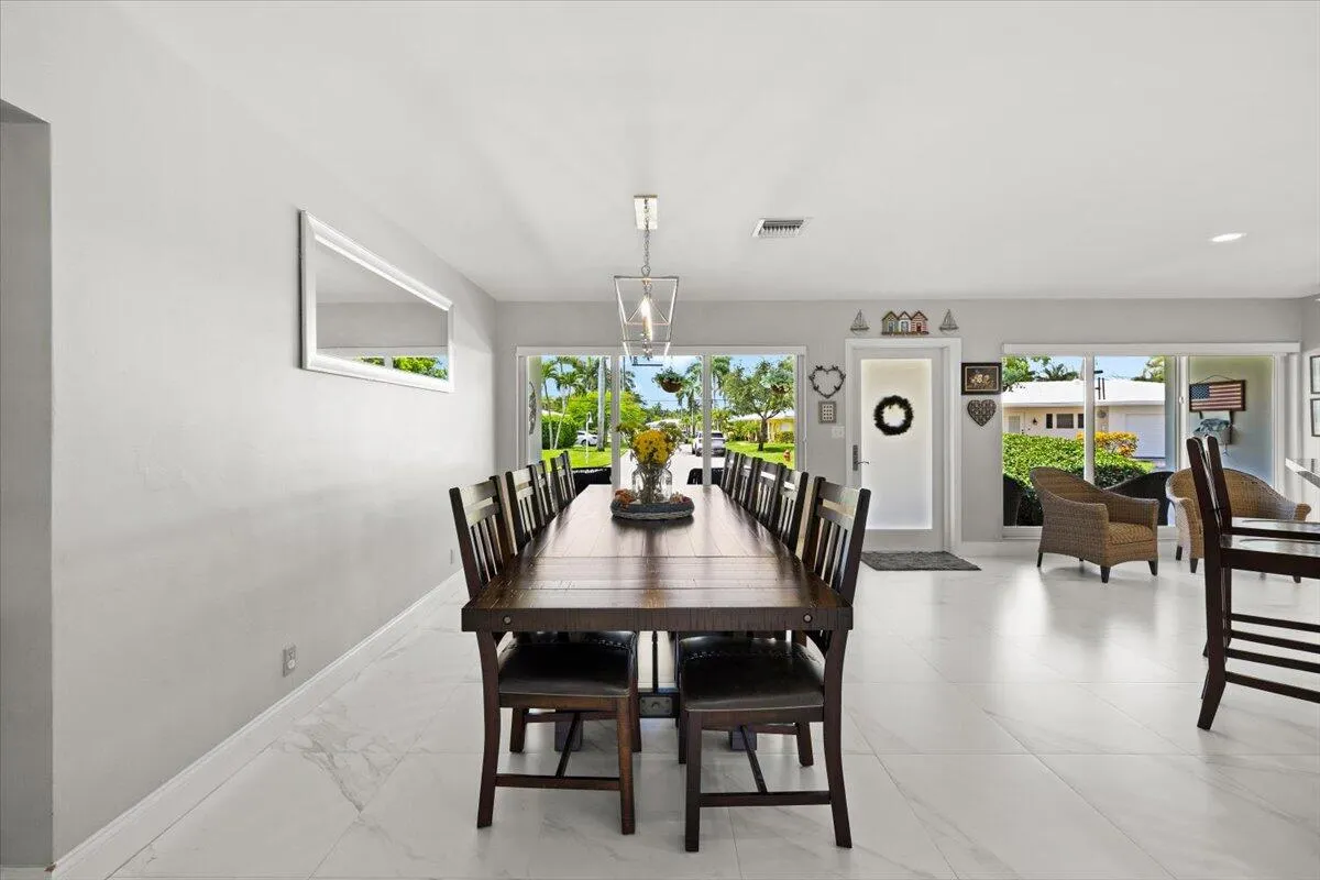 Open-concept living space featuring expansive white tile flooring and light-toned walls