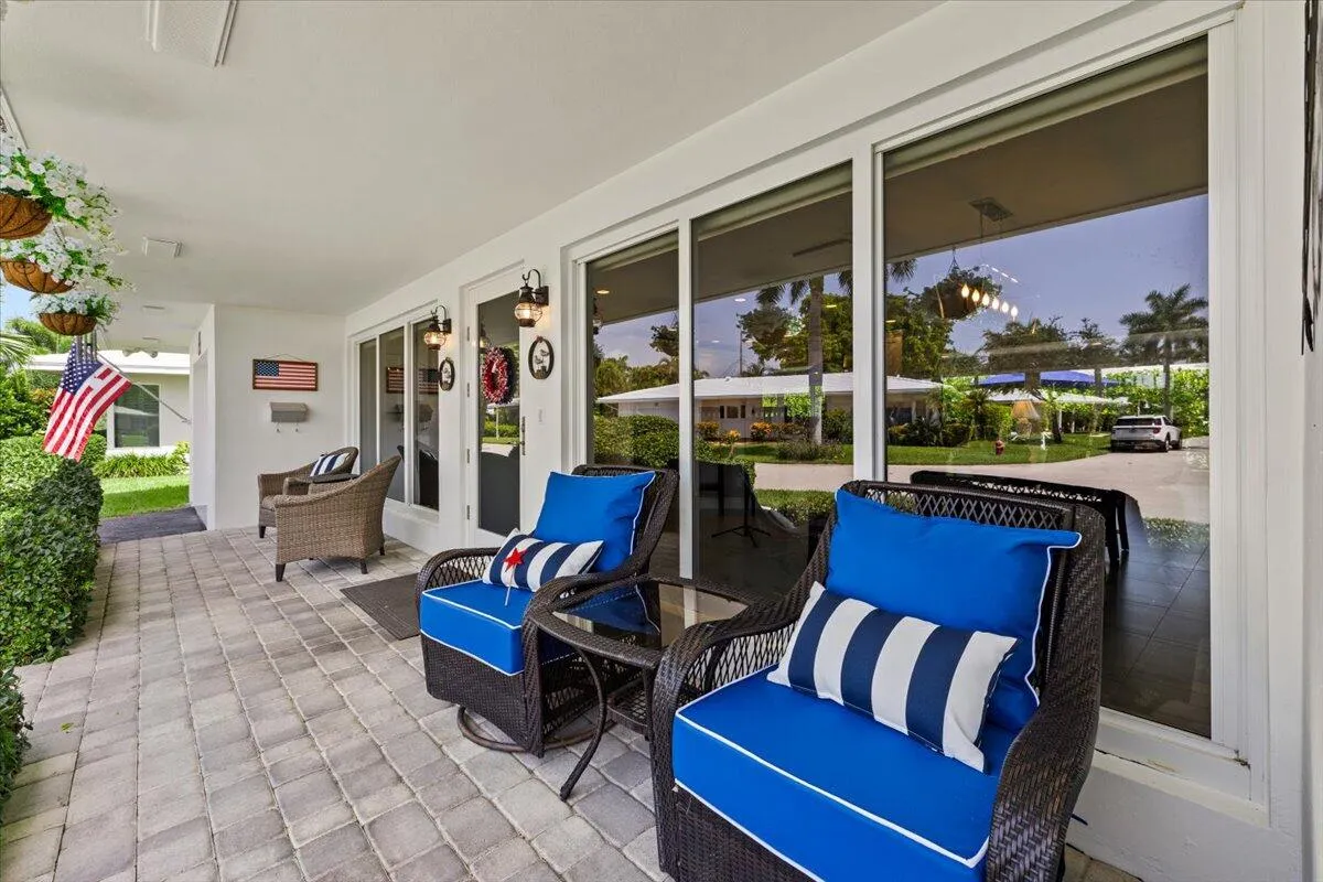 Covered patio featuring paver flooring
