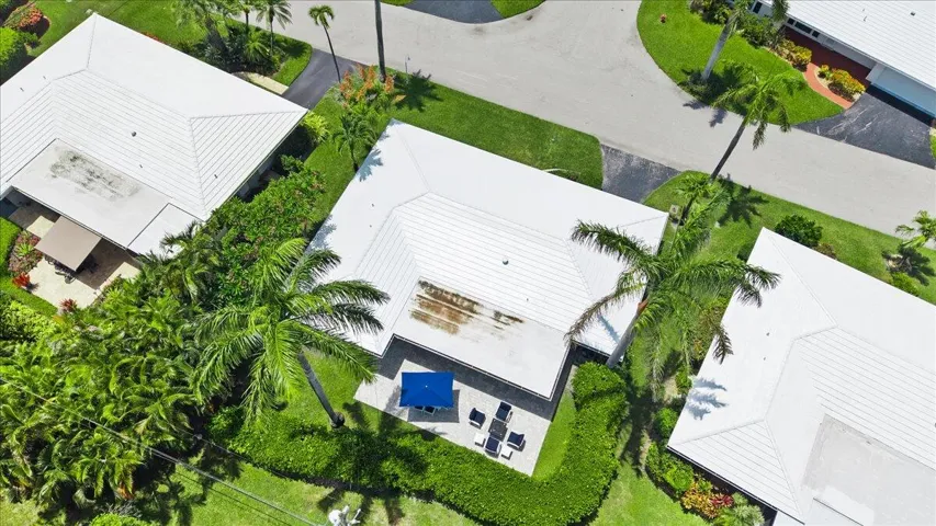 White rooflines against lush green landscaping