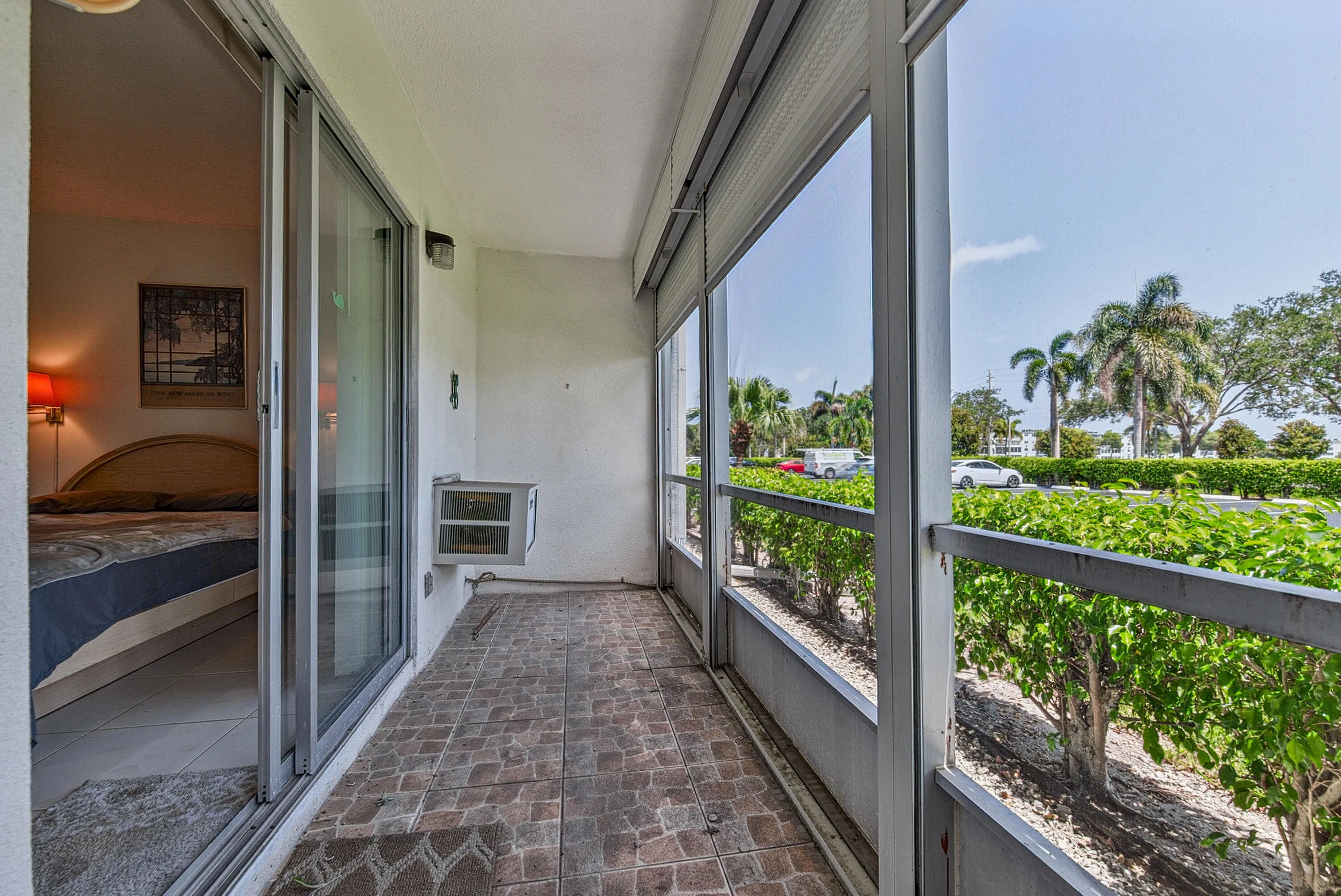 Screened patio featuring tile flooring and sliding glass door access