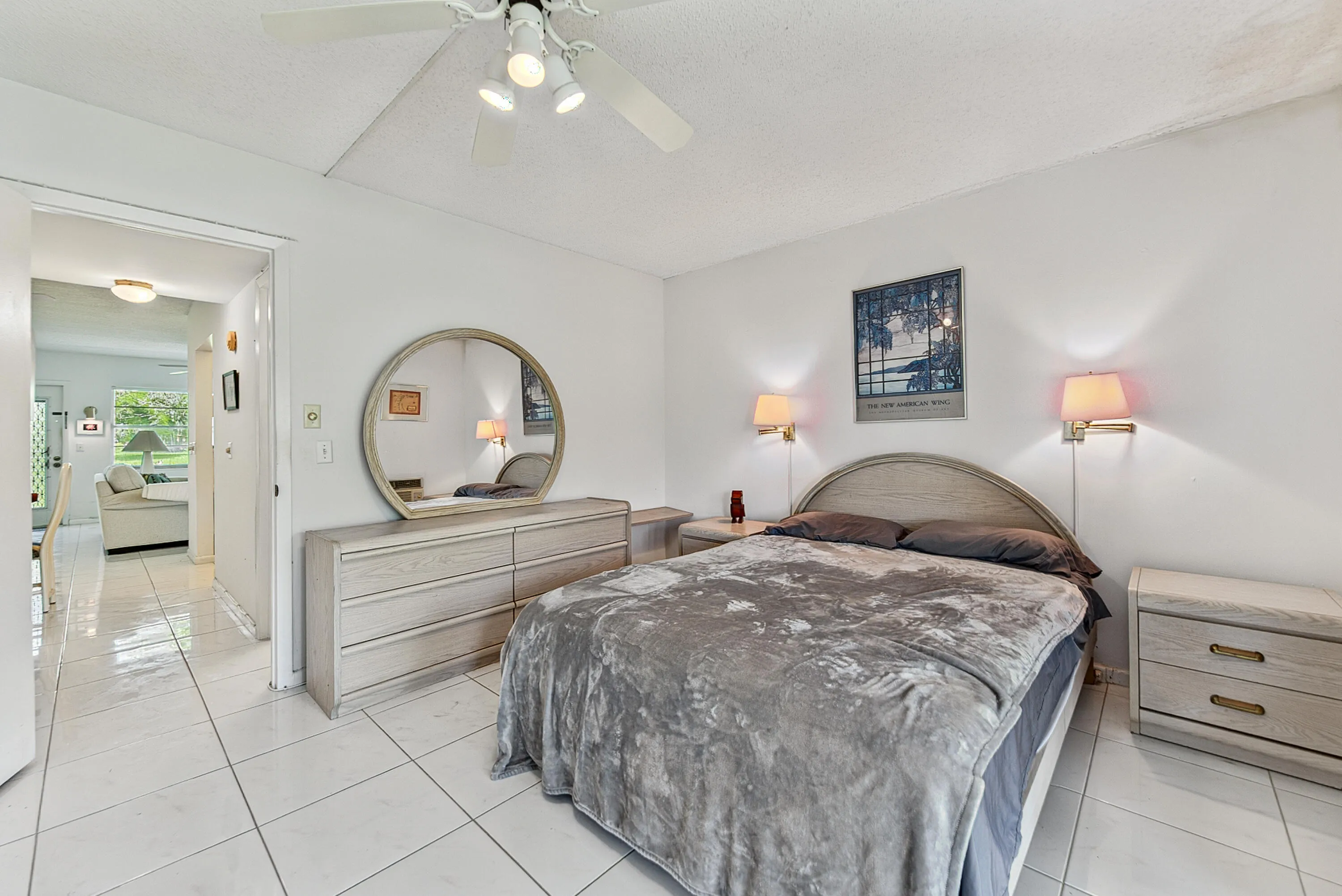 Light-colored tile flooring extending through the room and into the hallway