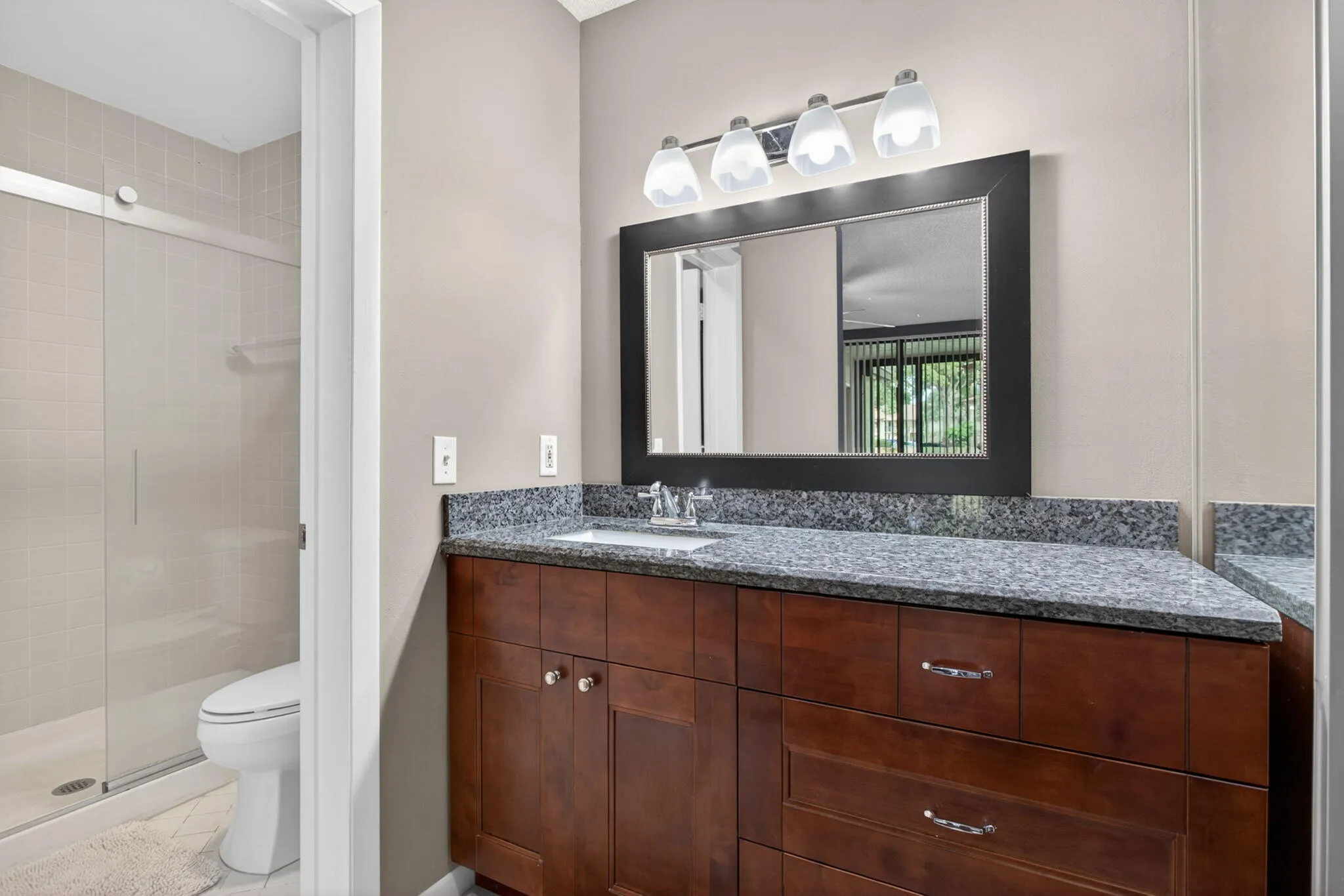 Second bath has a newer vanity and tub shower combo.