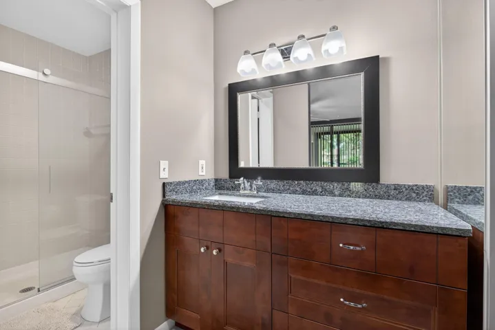 Second bath has a newer vanity and tub shower combo.