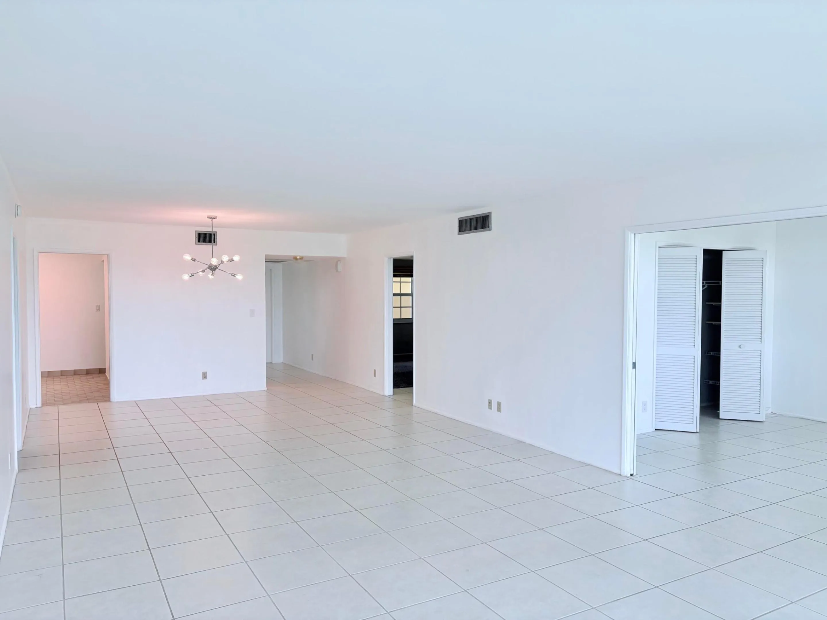 Living area. 3rd bedroom to the right with pocket doors.