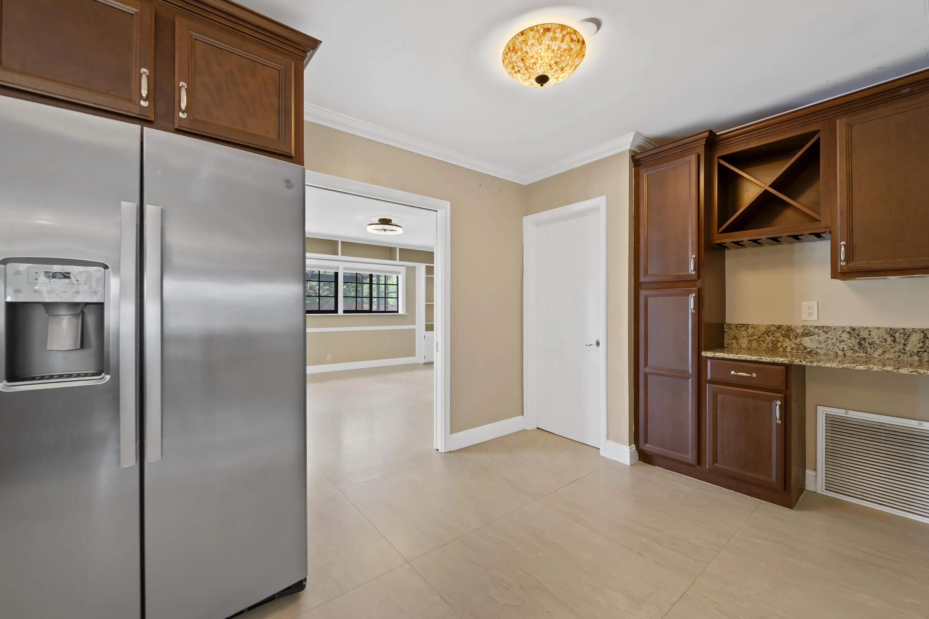 Kitchen space featuring a built-in wine rack and desk.