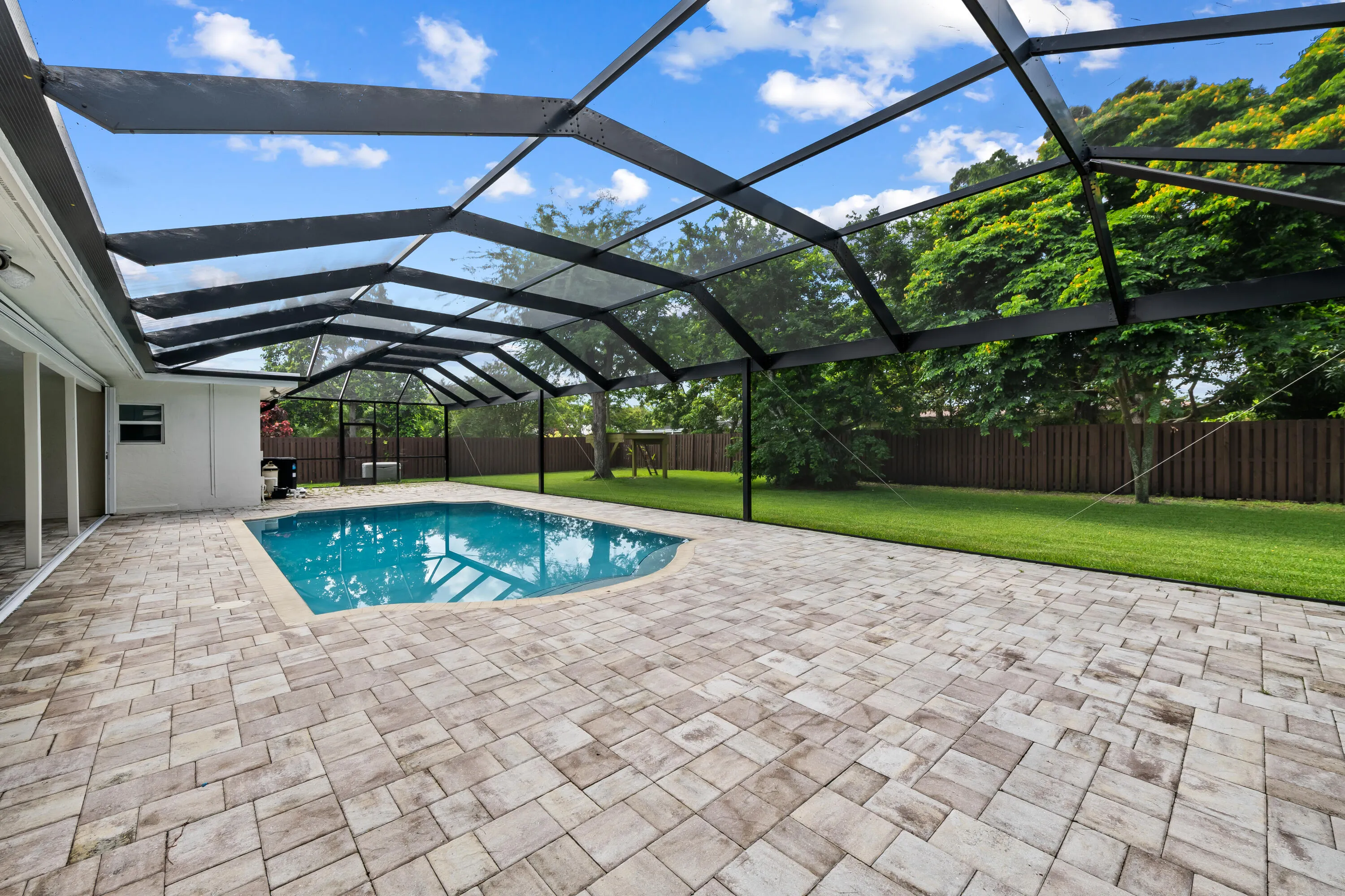 Seemless screen enclosure allows for a great view of the huge backyard.