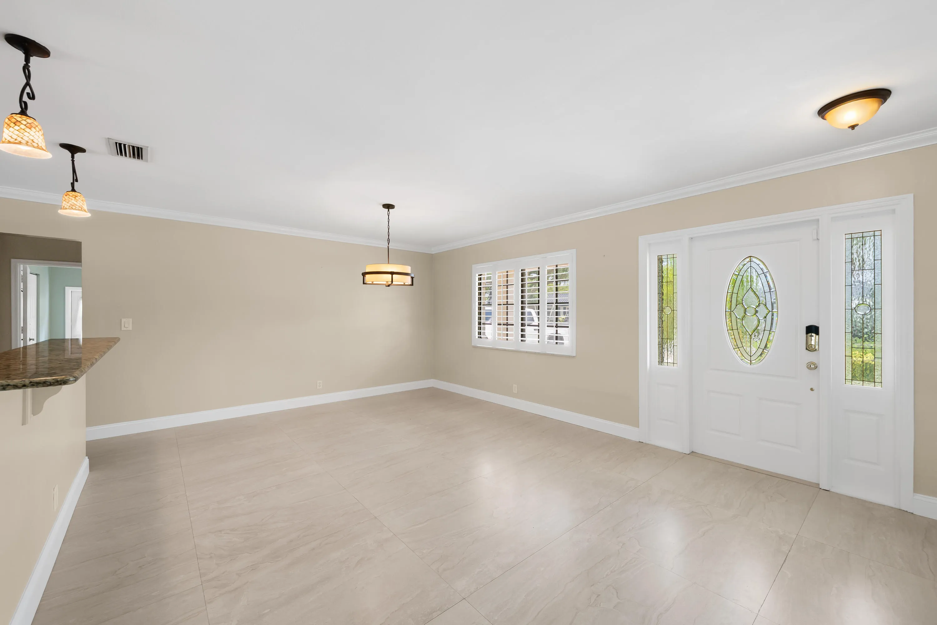 Entryway featuring a decorative glass oval-insert door, two full-length sidelights, and a transom window