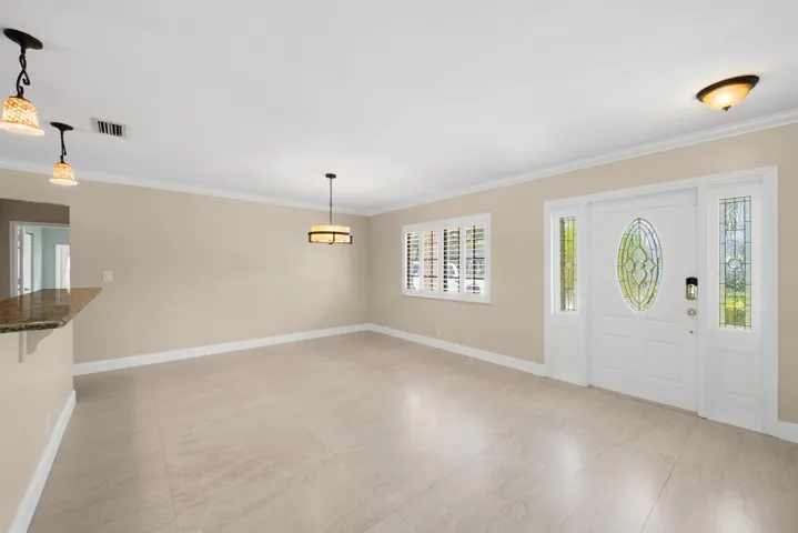 Entryway featuring a decorative glass oval-insert door, two full-length sidelights, and a transom window