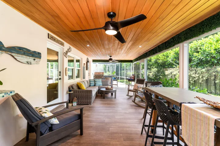 Huge outdoor living space with summer kitchen and pool all screened in