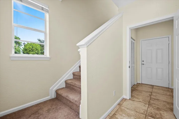 Staircase with carpeted treads and white risers