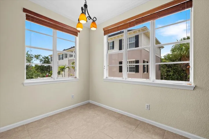 Recessed lighting, crown molding, and two multi-pane windows with integrated blinds