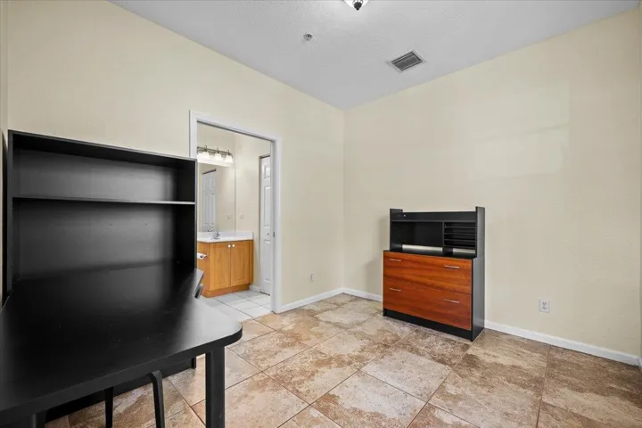 Versatile interior space featuring neutral wall tones and large format tile flooring