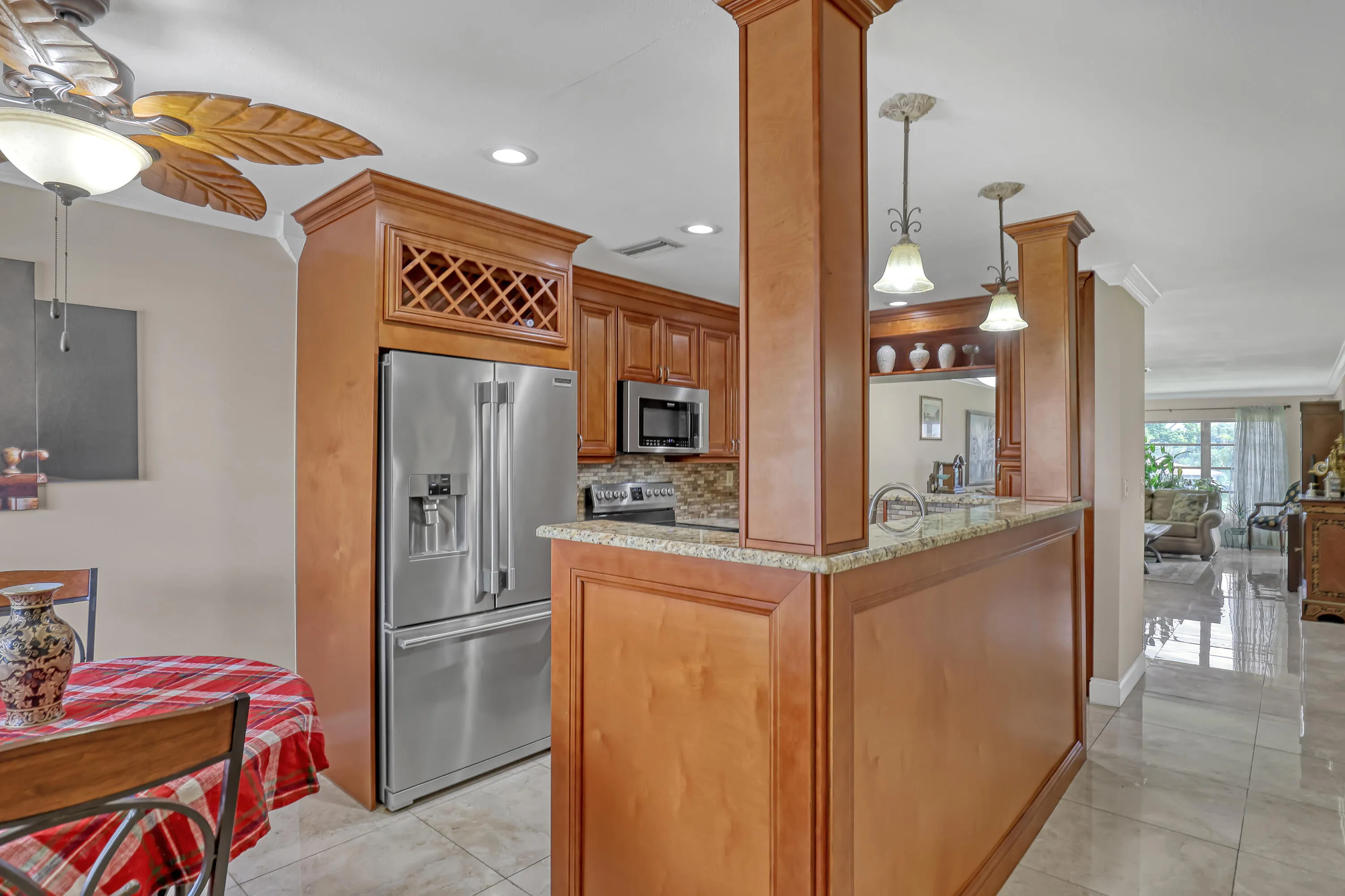 Kitchen featuring wood cabinetry, stainless steel refrigerator, and recessed lighting