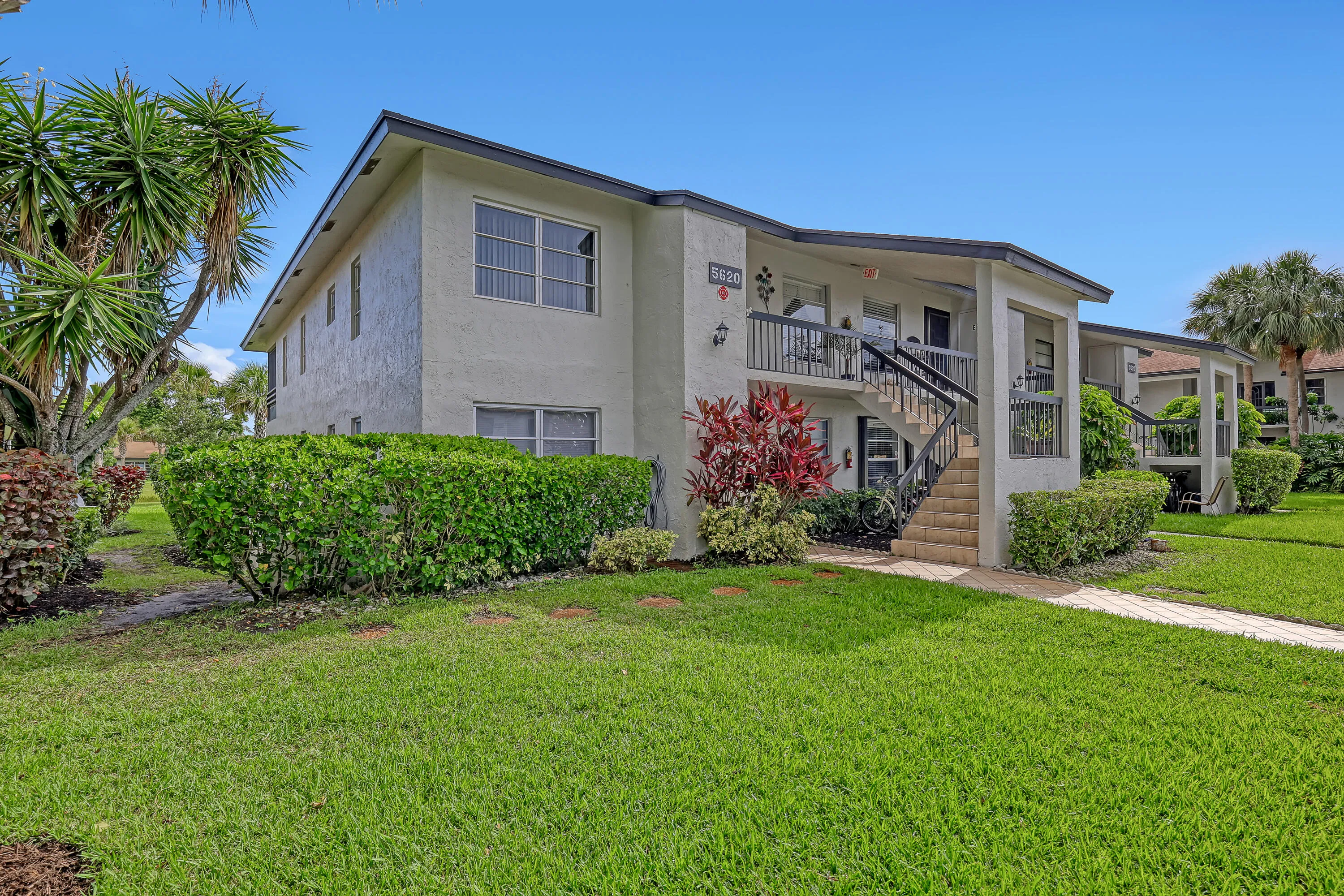 Two-story multi-unit structure with stucco exterior and dark trim