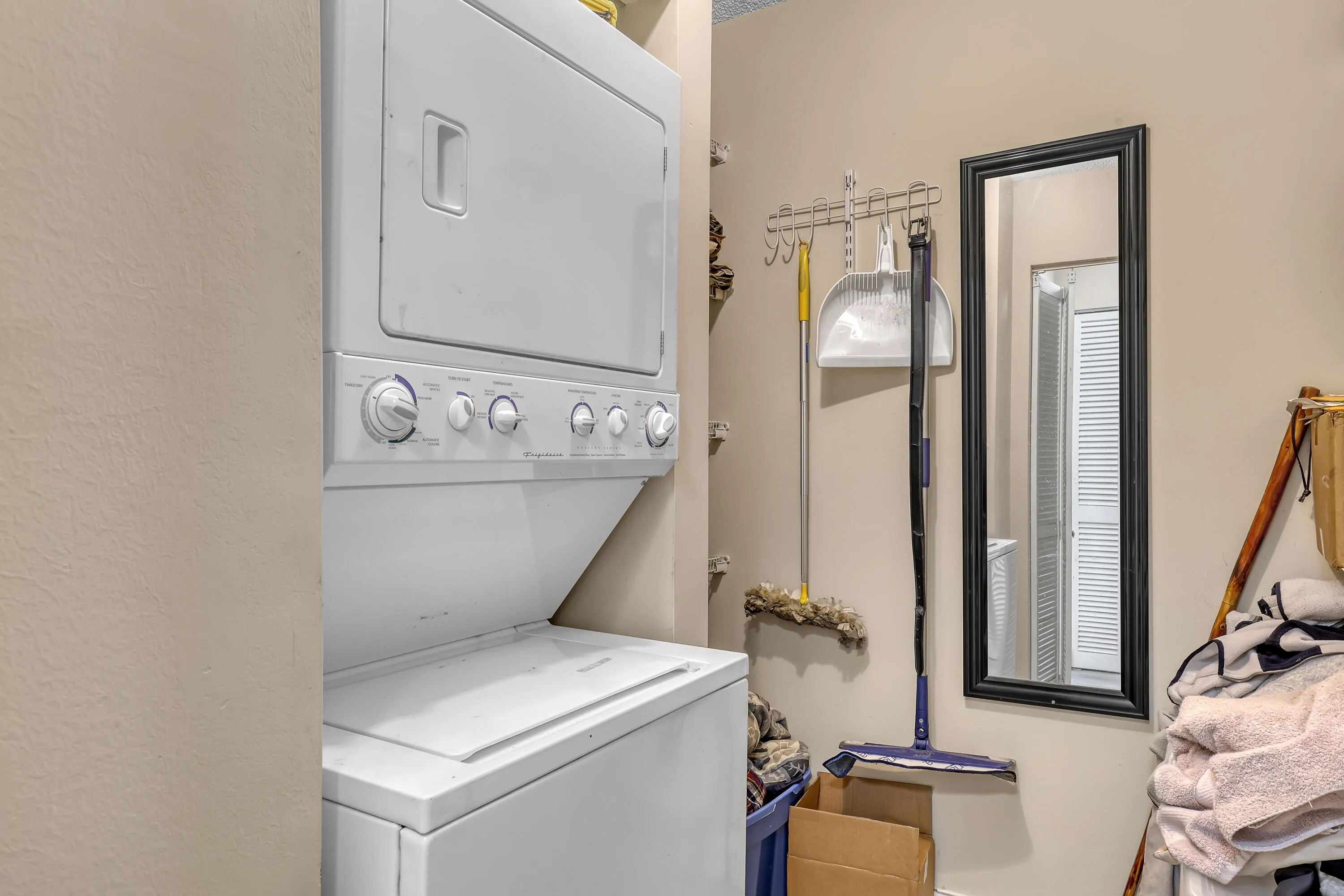 Laundry area featuring a stackable white washer and dryer unit