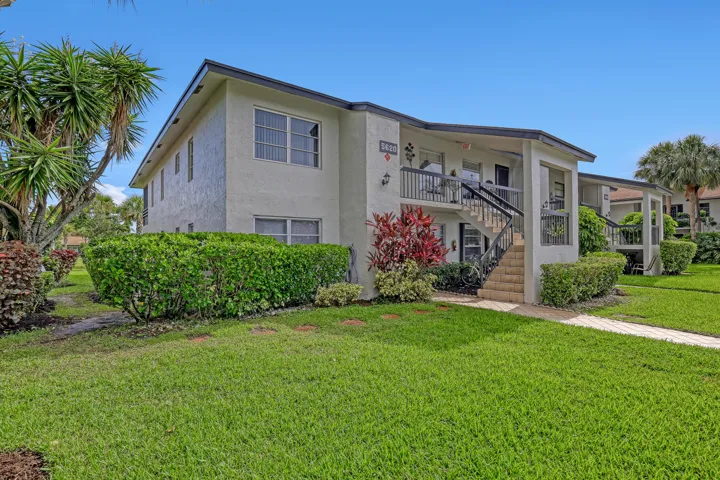 Two-story multi-unit structure with stucco exterior and dark trim