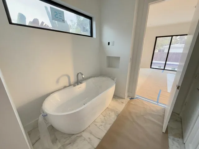 Main bathroom separate soaking tub complete with TV hookup.