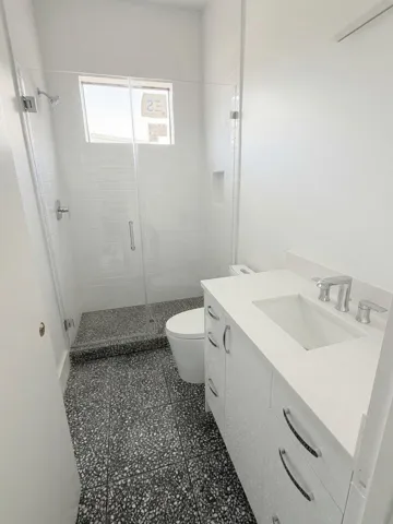 Guest bath with terrazzo tile flooring.