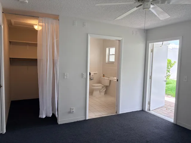 VIEW OF CLOSET, BATHROOM & BACK DOOR.