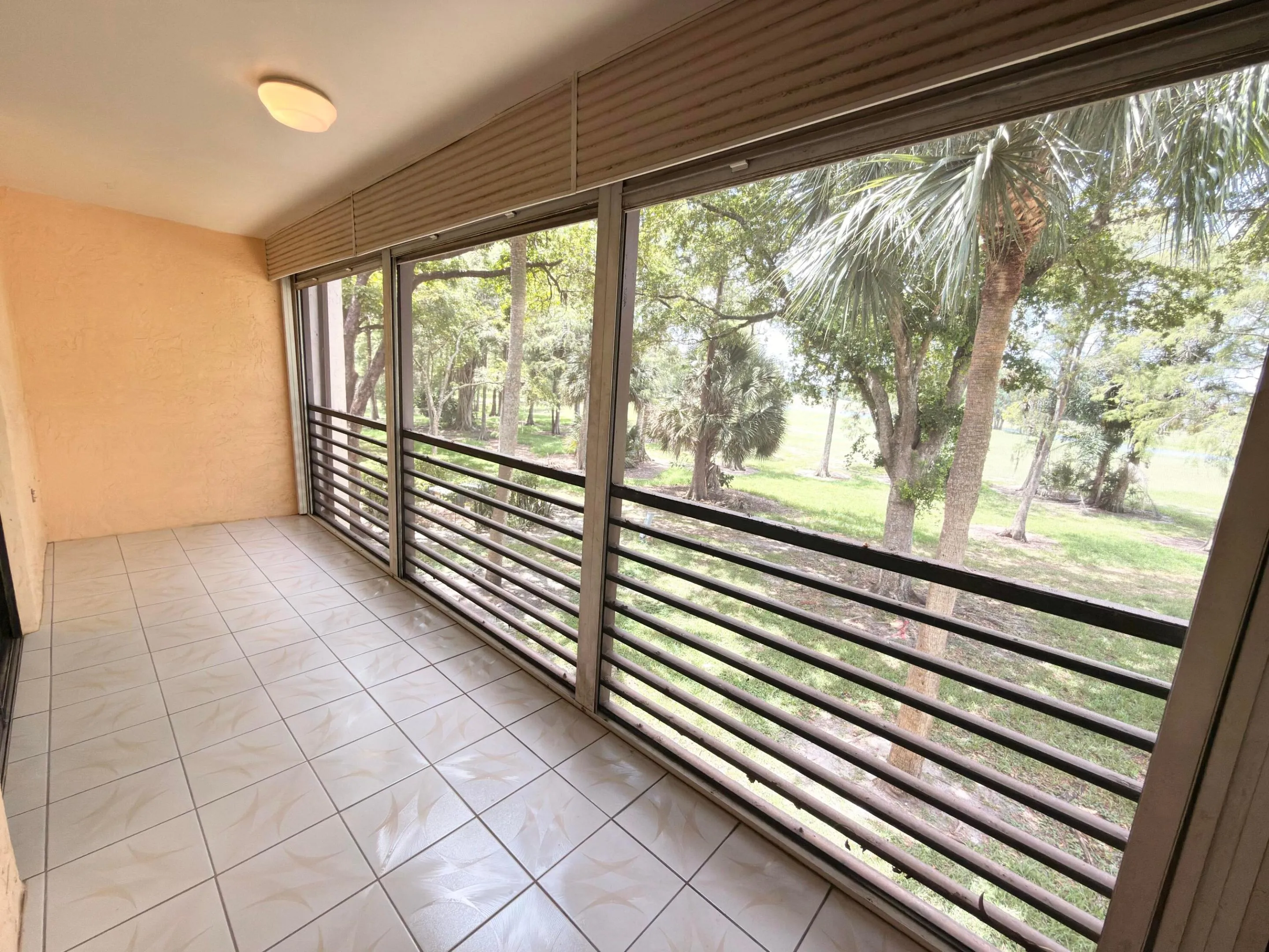 Balcony extends from primary bedroom to living room. Overlooks golf course and lake view plus pool view from the side.