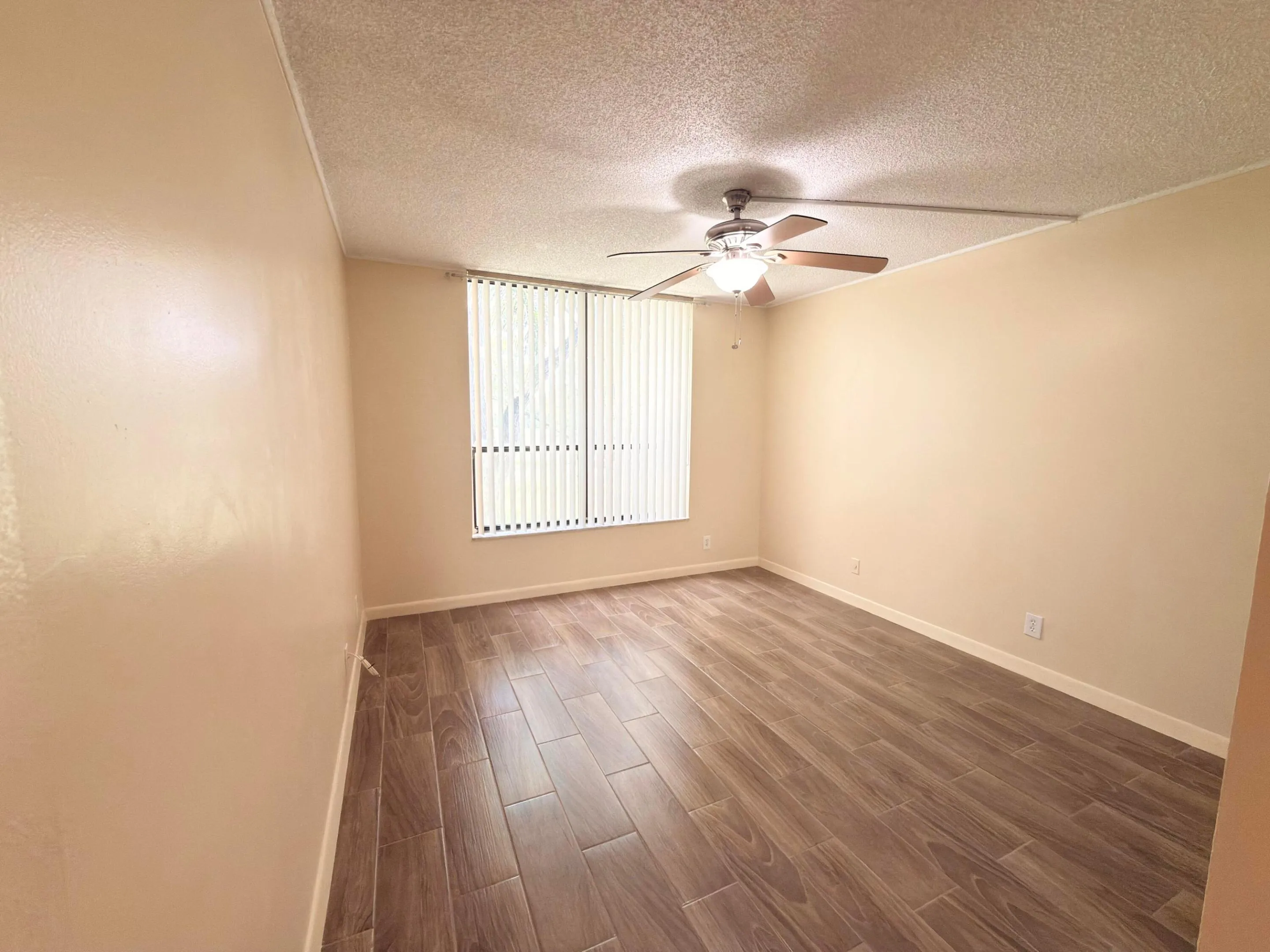 Spacious guest bedroom overlooks golf course.
