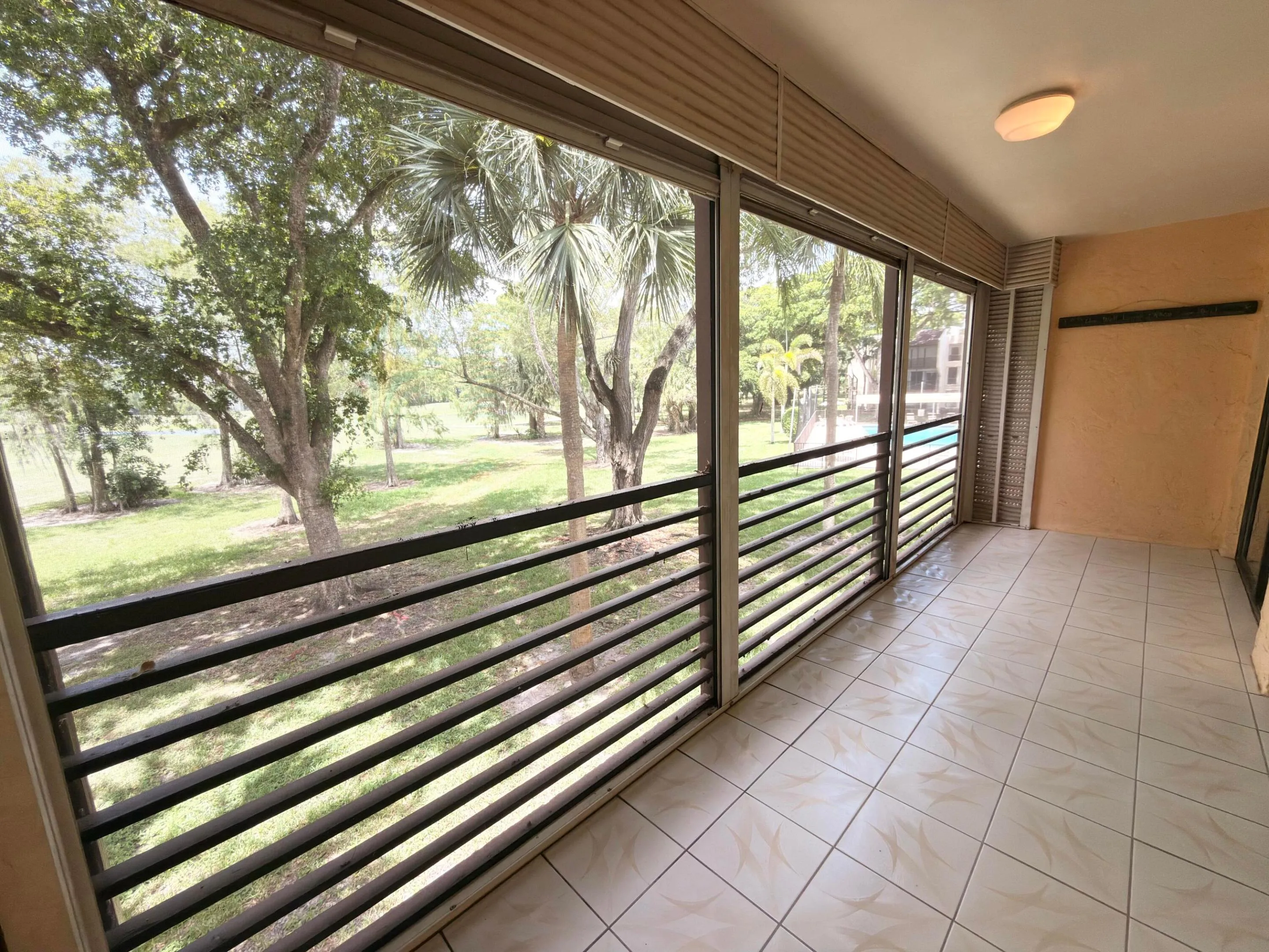 Balcony extends from primary bedroom to living room. Overlooks golf course and lake view plus pool view from the side.