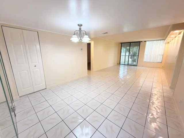 Spacious living/dining room with lots of light and natural sunlight. Plus access to balcony overlooking golf/lake/pool.