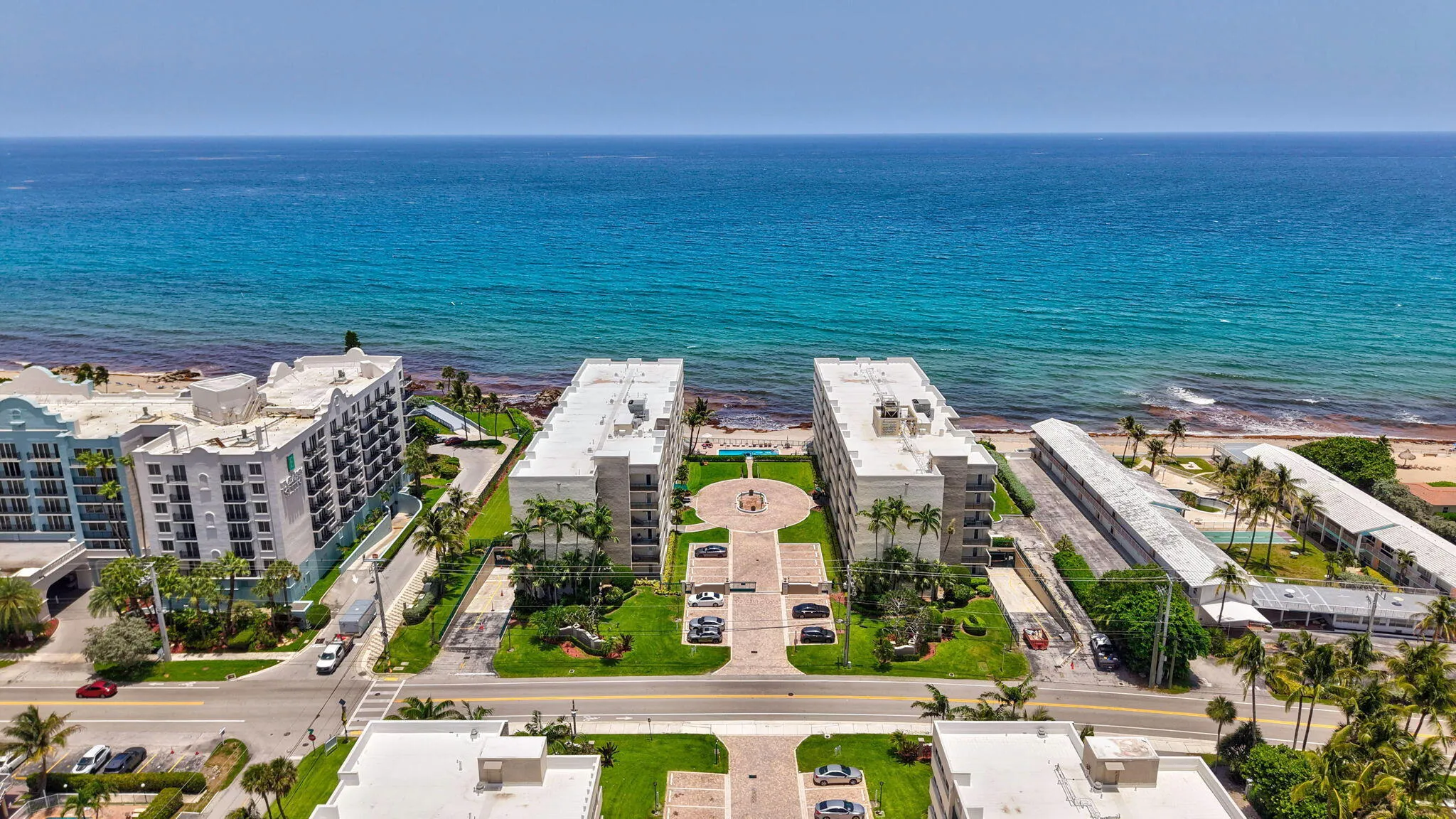Oceanfront property featuring twin multi-story residential buildings with direct beach access